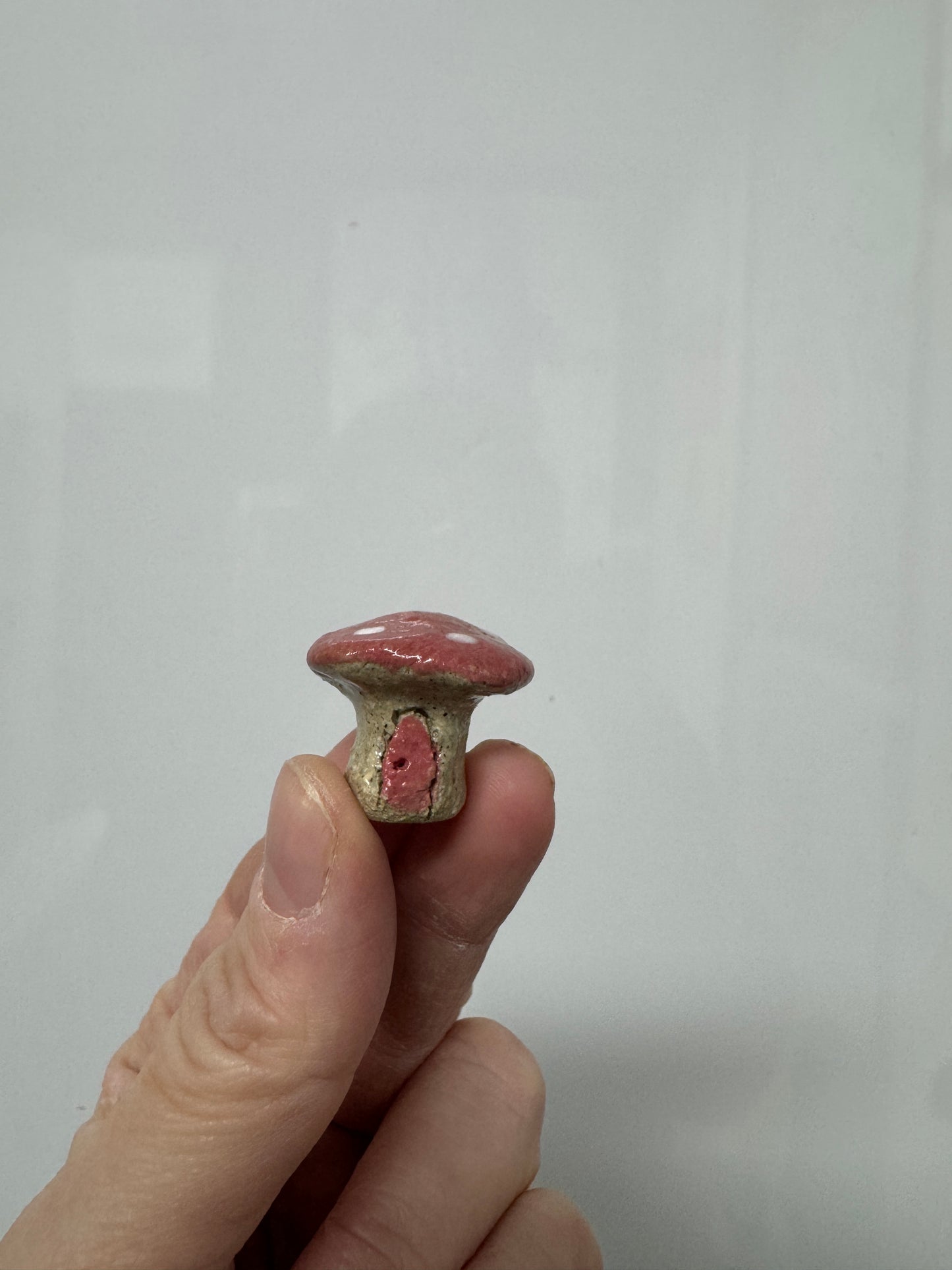 Handmade ceramic mini mushroom ornament for fairy garden and indoor plant decor.