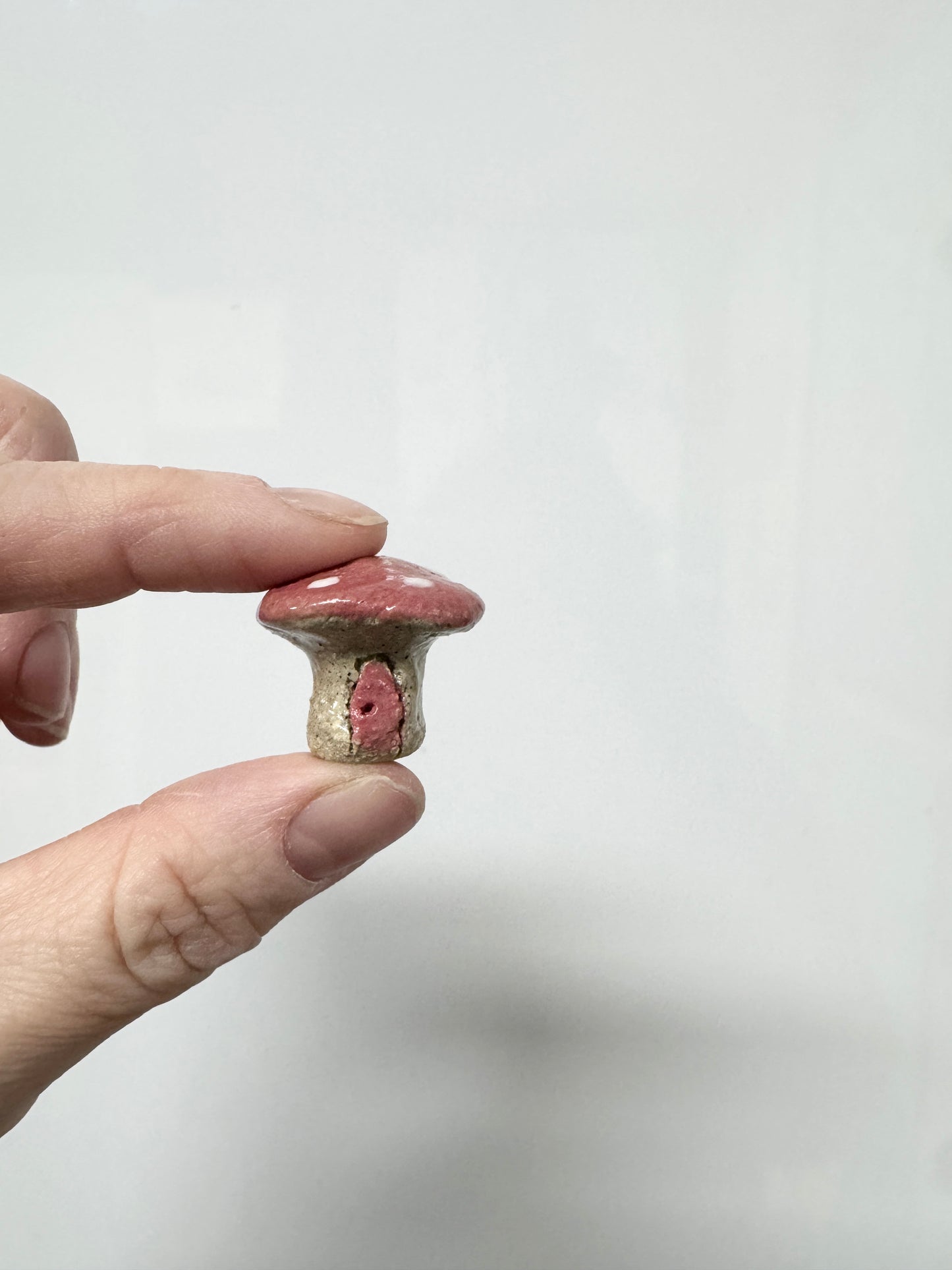 Handmade ceramic mini mushroom ornament for fairy garden and indoor plant decor.