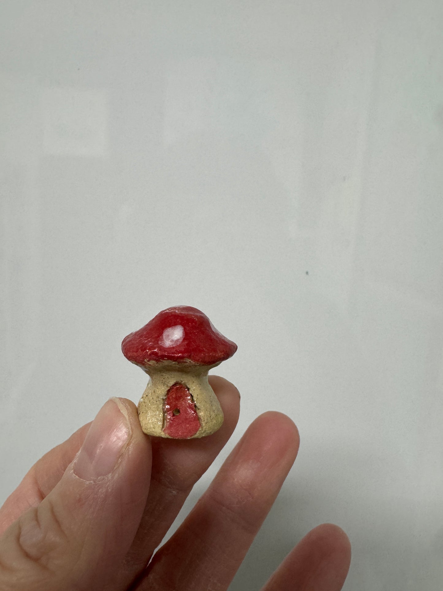 Handmade ceramic mini mushroom ornament for fairy garden and indoor plant decor.