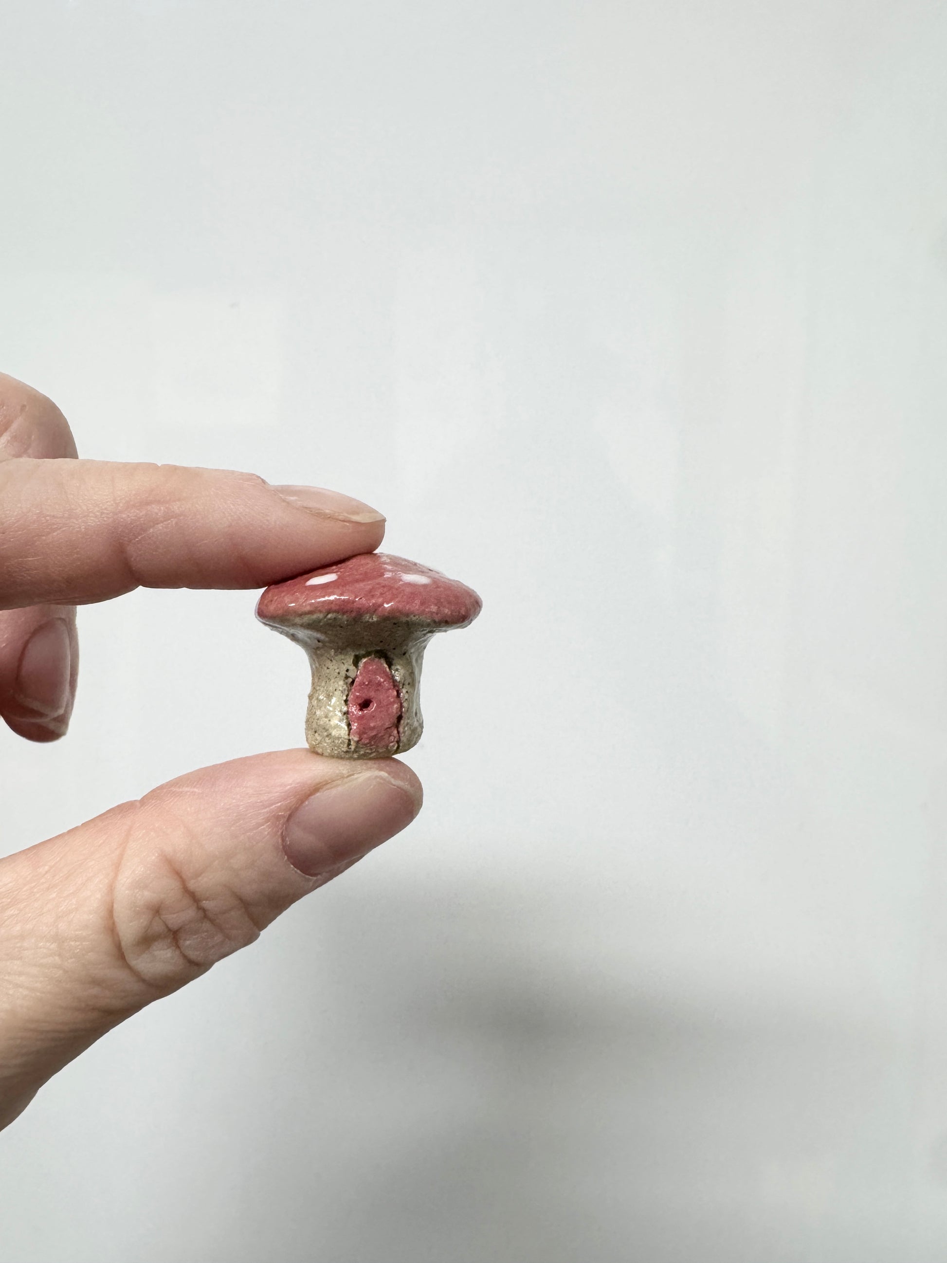 Handmade ceramic mini mushroom ornament for fairy garden and indoor plant decor.