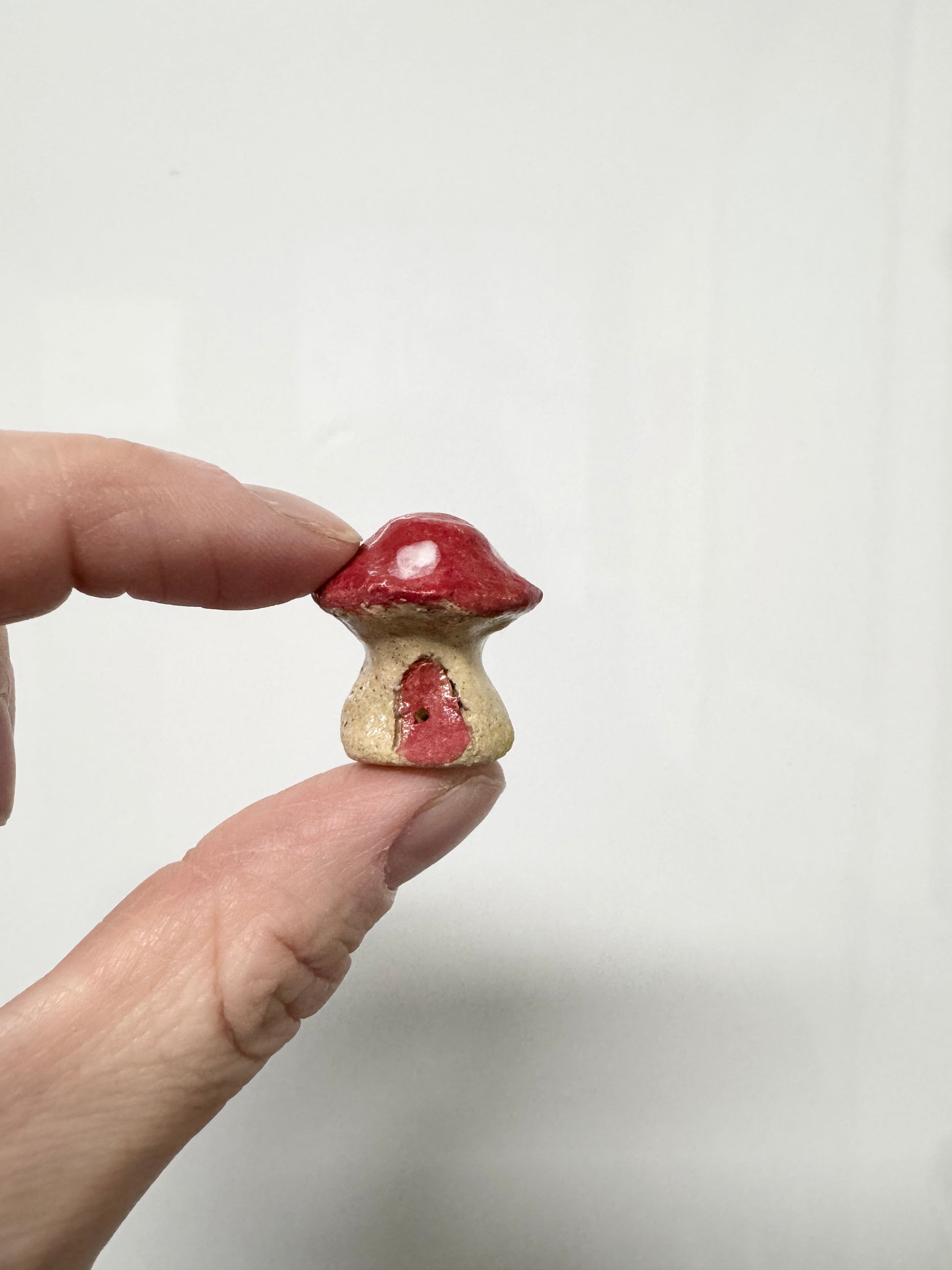 Handmade ceramic mini mushroom ornament for fairy garden and indoor plant decor.